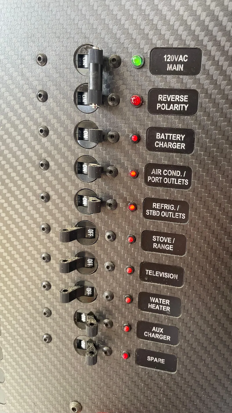 Slide: The Image of Electrical panel of a 1967 Hatteras 28 Cruiser with labeled switches and indicators. - 47