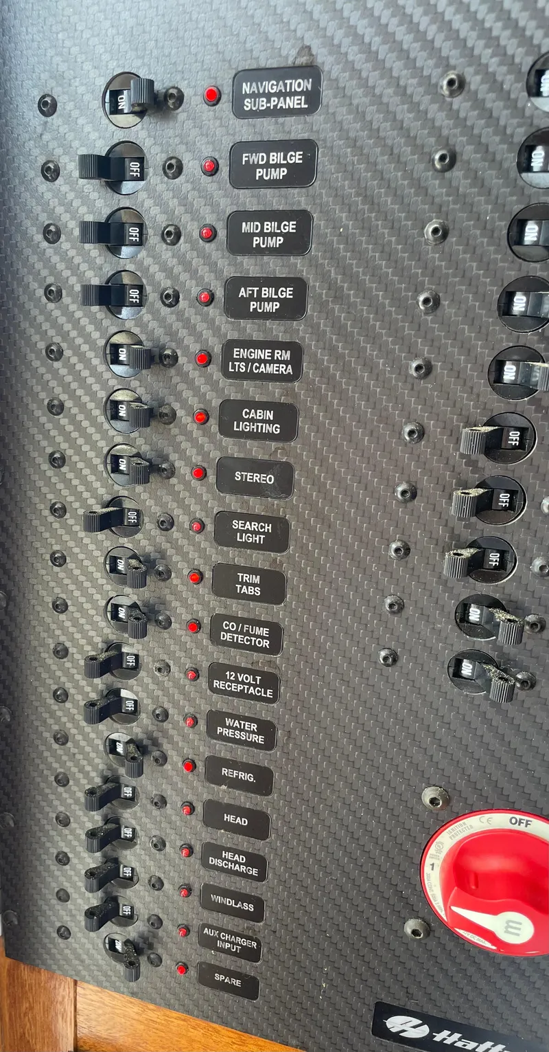 Slide: The Image of Control panel of a 1967 Hatteras 28 Cruiser boat with labeled switches and red dial. - 49