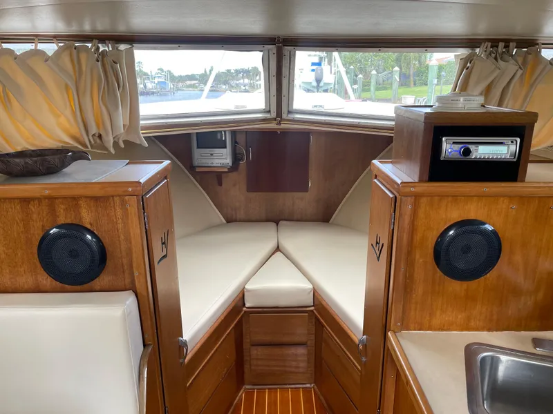 Slide: The Image of Interior of a 1967 Hatteras 28 Cruiser with wood paneling and cushioned seating. - 7