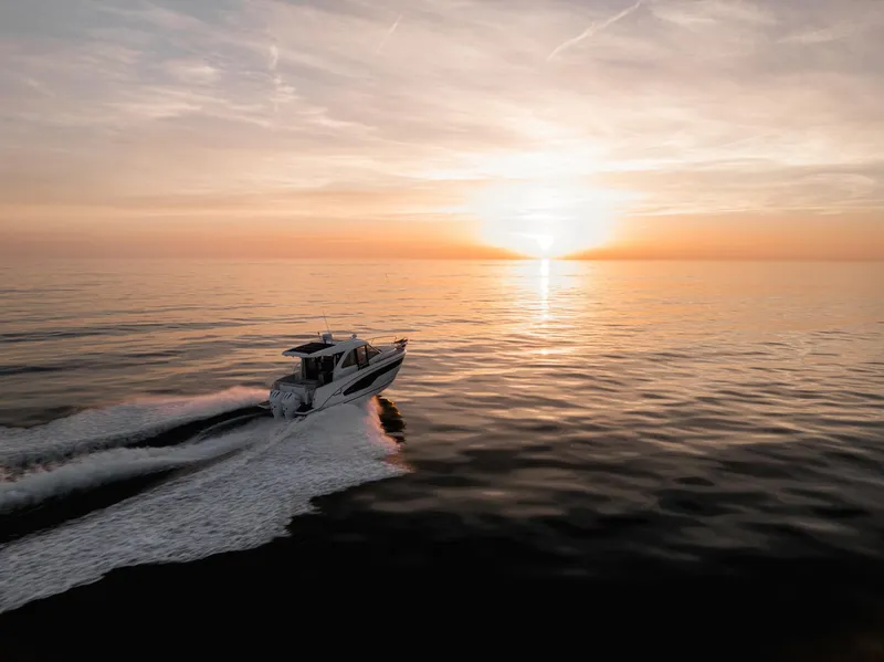 Slide: The Image of 2025 Beneteau Antares 9 cruising at sunset on calm waters. - 11