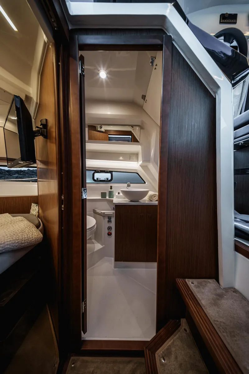 Slide: The Image of Interior of 2025 Beneteau Antares 9, featuring modern wood finishes and compact design. - 16
