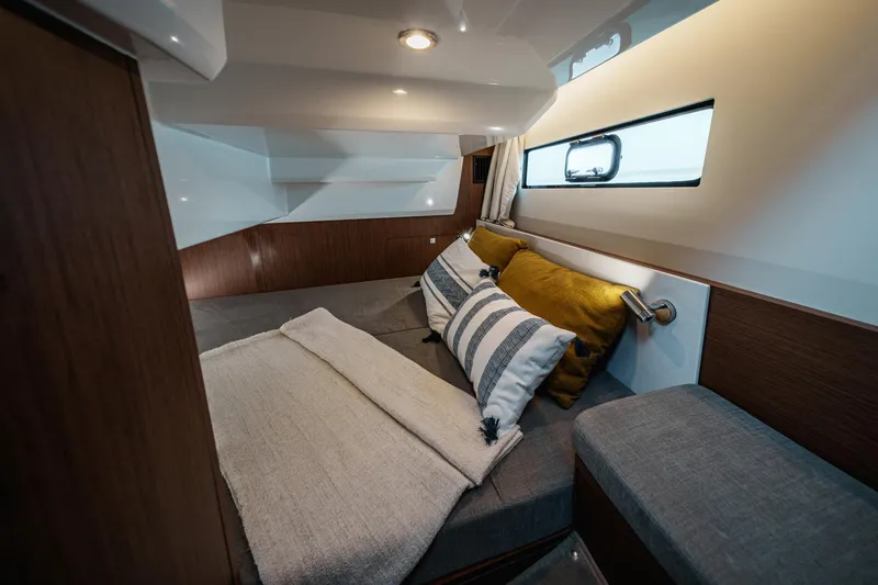 Slide: The Image of 2025 Beneteau Antares 9 cabin interior with cozy bedding and modern design. - 19