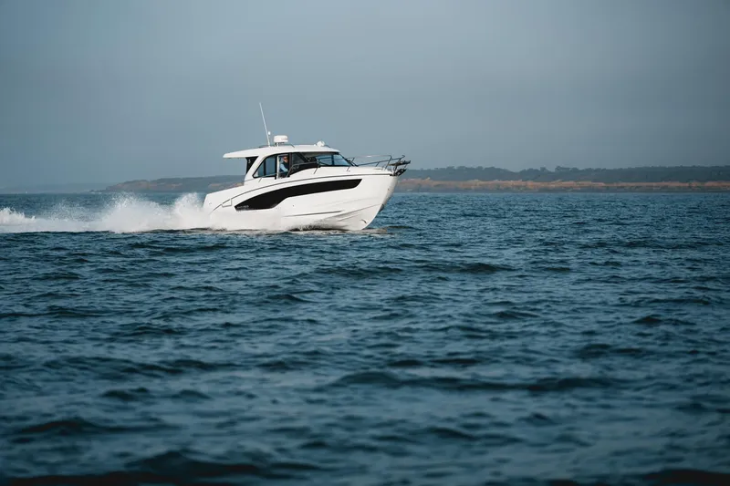 Slide: The Image of 2025 Beneteau Antares 9 cruising on open water, showcasing sleek design and performance. - 2