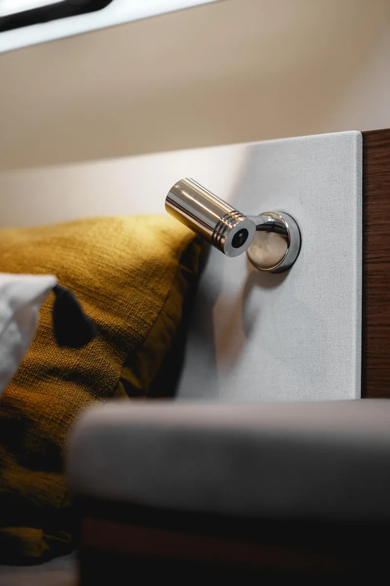 Slide: The Image of Interior detail of 2025 Beneteau Antares 9, featuring modern lighting and cozy cushions. - 22