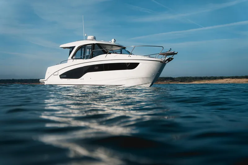 Slide: The Image of 2025 Beneteau Antares 9 boat on calm water under blue sky. - 3