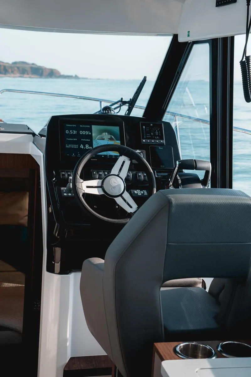 Slide: The Image of 2025 Beneteau Antares 9 helm with modern controls and ocean view. - 30