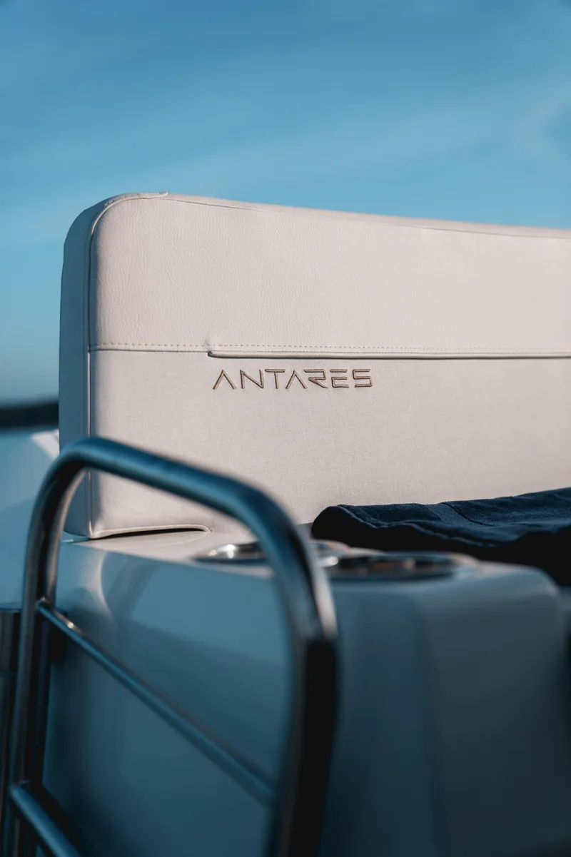 Slide: The Image of 2025 Beneteau Antares 9 boat seat with logo, blue sky background. - 37
