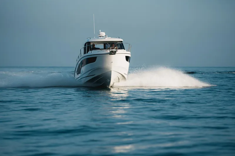 Slide: The Image of 2025 Beneteau Antares 9 cruising on open water, creating a dynamic wake. - 5