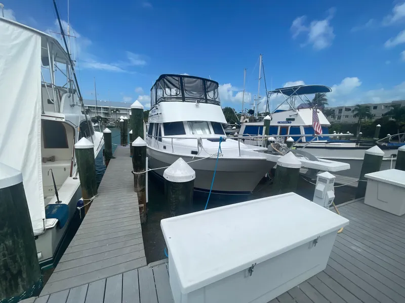 Slide: The Image of 1999 Mainship 430 Trawler docked at marina under clear blue sky. - 27