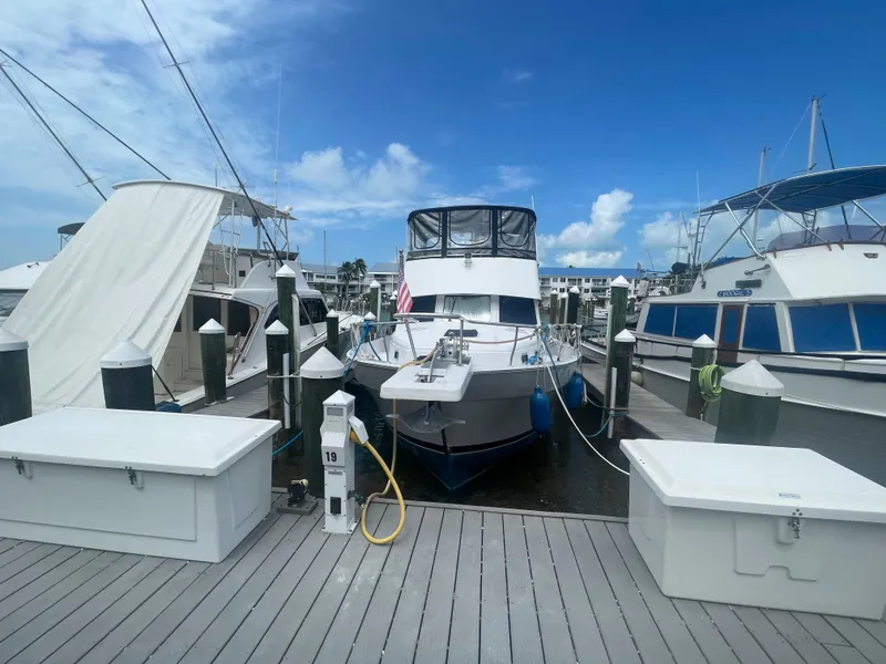 Slide: The Image of 1999 Mainship 430 Trawler docked at marina under clear blue sky. - 3