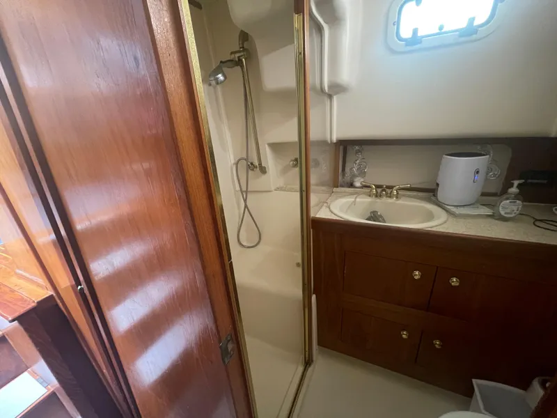 Slide: The Image of Bathroom interior of 1999 Mainship 430 Trawler with shower and sink. - 45