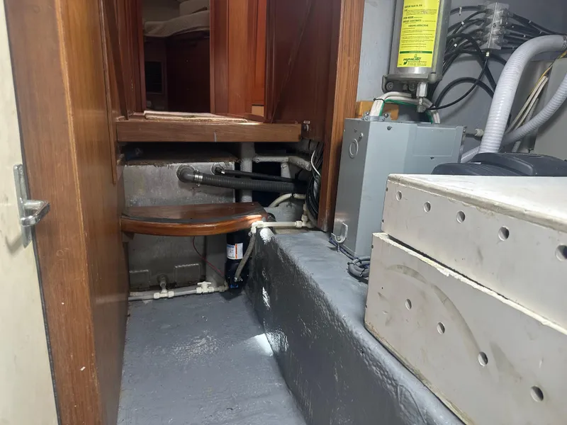 Slide: The Image of Engine room of 1999 Mainship 430 Trawler with visible pipes and equipment. - 47