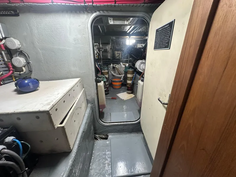 Slide: The Image of 1999 Mainship 430 Trawler interior, showing engine room access and storage area. - 48