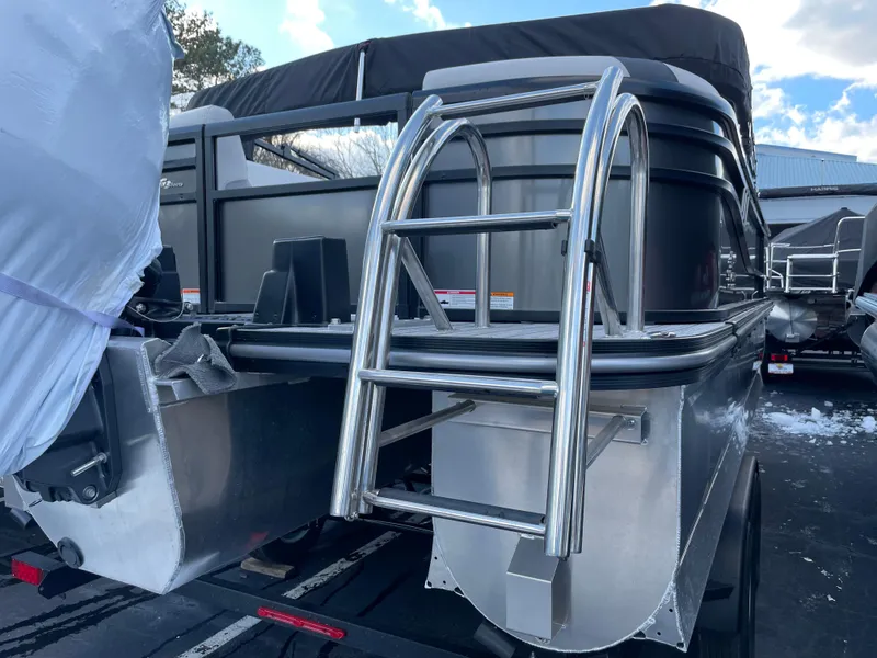 Slide: The Image of 2025 SunCatcher Select 322RC pontoon boat with stainless steel ladder and sleek design. - 15