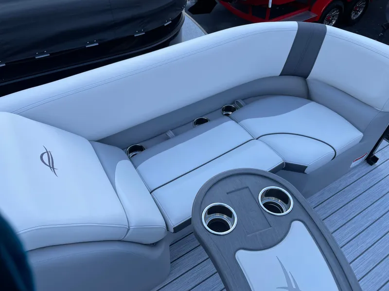 Slide: The Image of 2025 SunCatcher Select 322RC boat interior with gray seating and cup holders. - 6