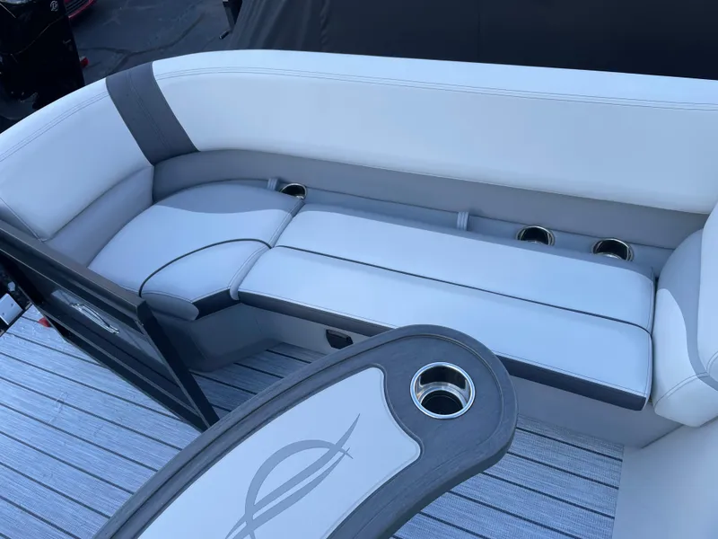 Slide: The Image of 2025 SunCatcher Select 322RC boat interior with cushioned seating and cup holders. - 7