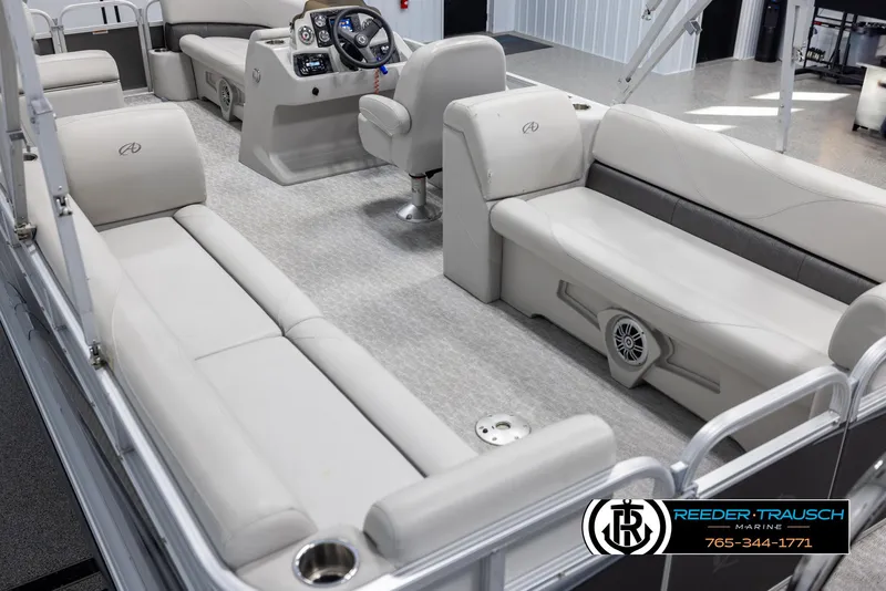 Slide: The Image of 2021 Avalon VLS QL pontoon boat interior with beige seating and modern dashboard. - 11