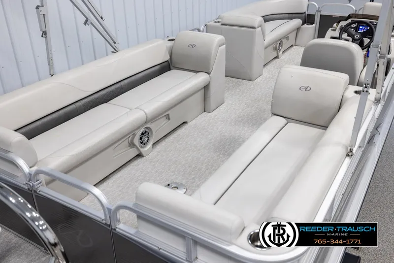 Slide: The Image of 2021 Avalon VLS QL pontoon boat interior with beige seating and modern design. - 12