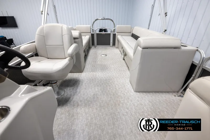 Slide: The Image of Interior of 2021 Avalon VLS QL pontoon boat with plush seating and steering console. - 14