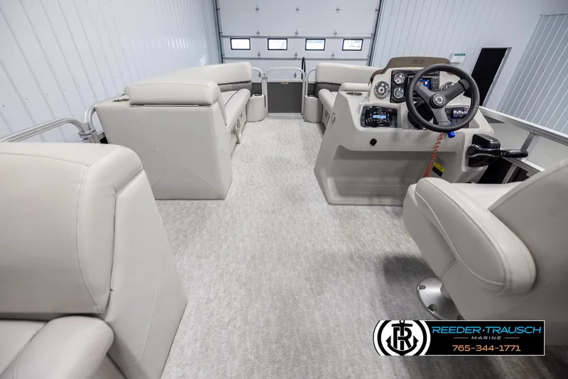 Slide: The Image of 2021 Avalon VLS QL boat interior with beige seating and modern dashboard. - 17