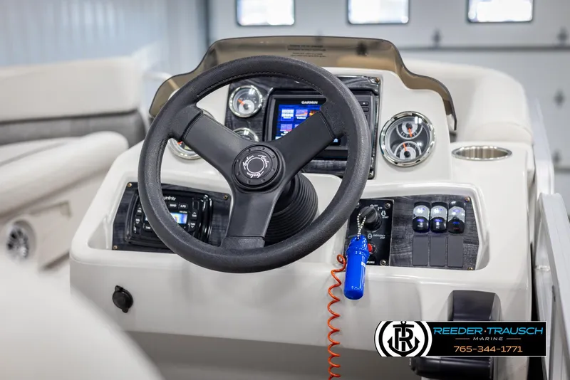 Slide: The Image of 2021 Avalon VLS QL boat steering console with controls and gauges. - 24