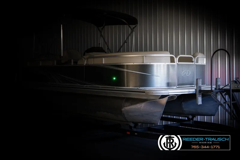 Slide: The Image of 2021 Avalon VLS QL pontoon boat in a dimly lit storage area. - 4