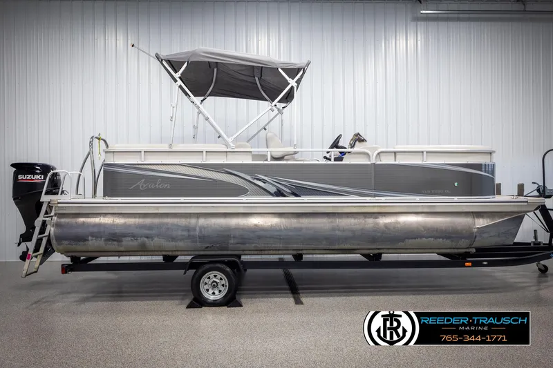 Slide: The Image of 2021 Avalon VLS QL pontoon boat with Suzuki motor on trailer in showroom. - 5