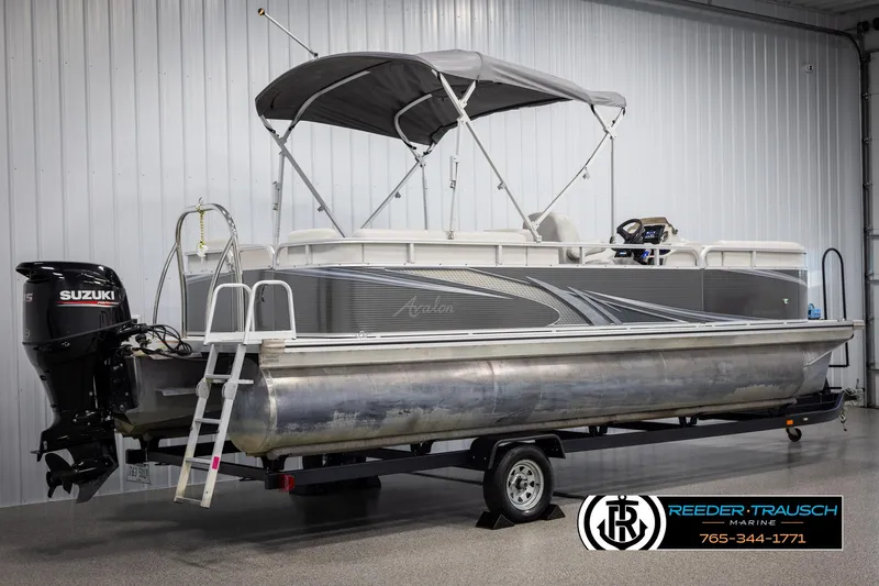 Slide: The Image of 2021 Avalon VLS QL pontoon boat with Suzuki outboard motor on trailer. - 6