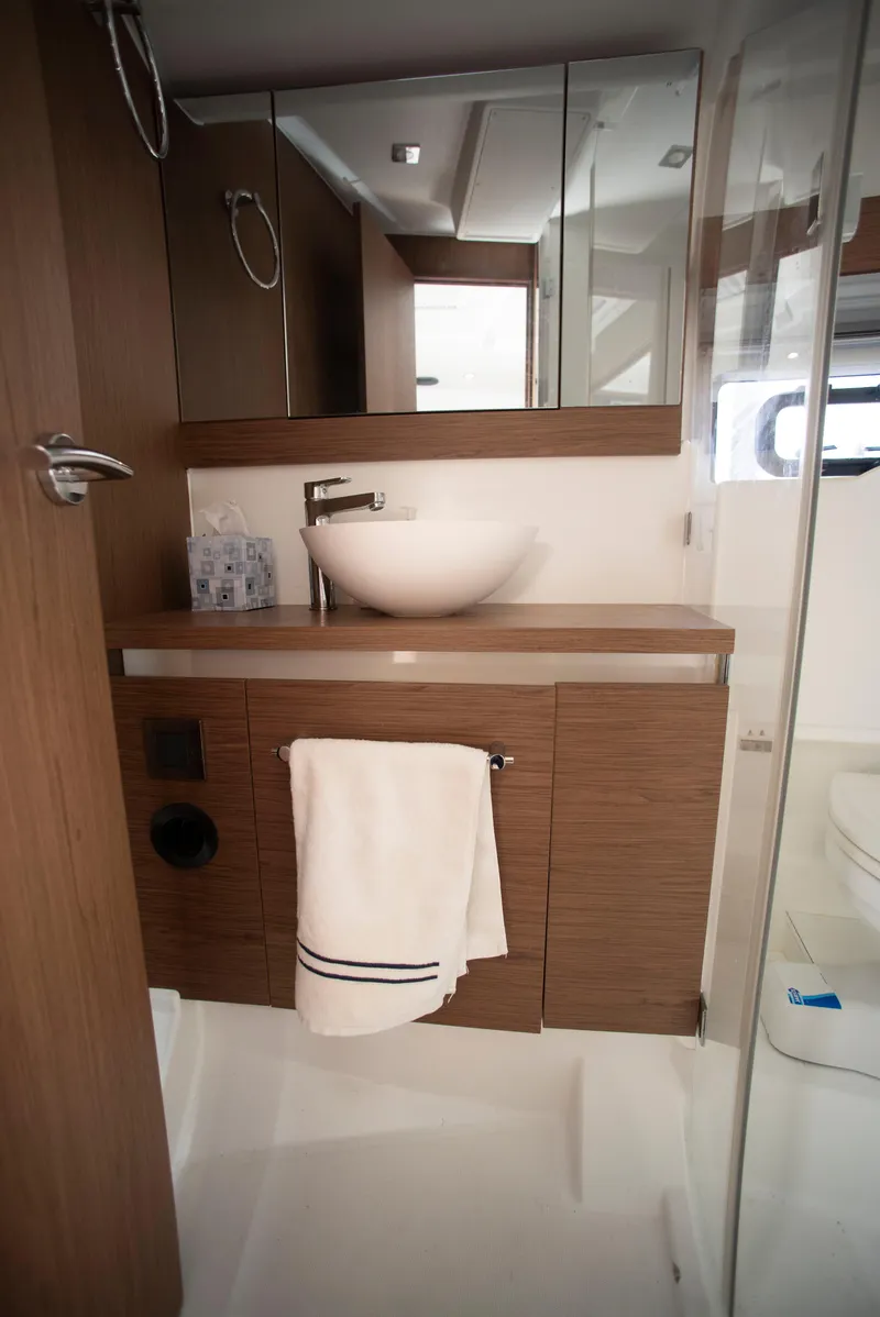 Slide: The Image of 2017 Jeanneau Leader 40 bathroom with modern sink and wooden cabinetry. - 39