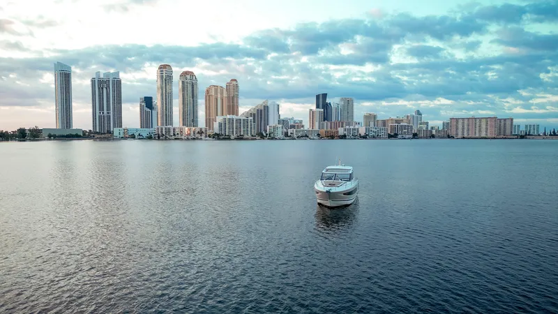 Slide: The Image of Jeanneau Leader 40 yacht on calm water with city skyline, 2017 model. - 45