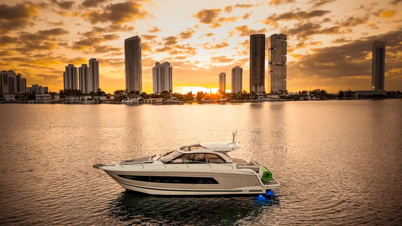 Slide: The Image of Jeanneau Leader 40 yacht on water at sunset, city skyline in background, 2017 model. - 47