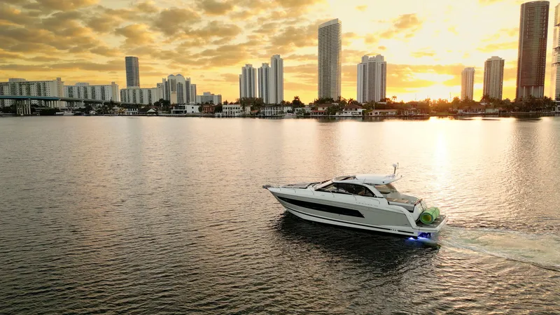 Slide: The Image of Jeanneau Leader 40 yacht cruising at sunset near city skyline, 2017 model. - 48