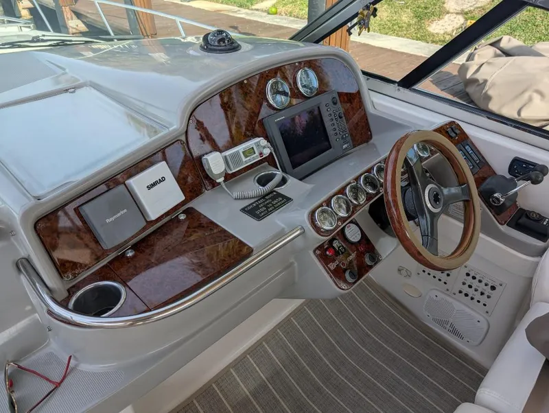 Slide: The Image of 2002 Formula 41 PC boat dashboard with wood accents and modern navigation equipment. - 10
