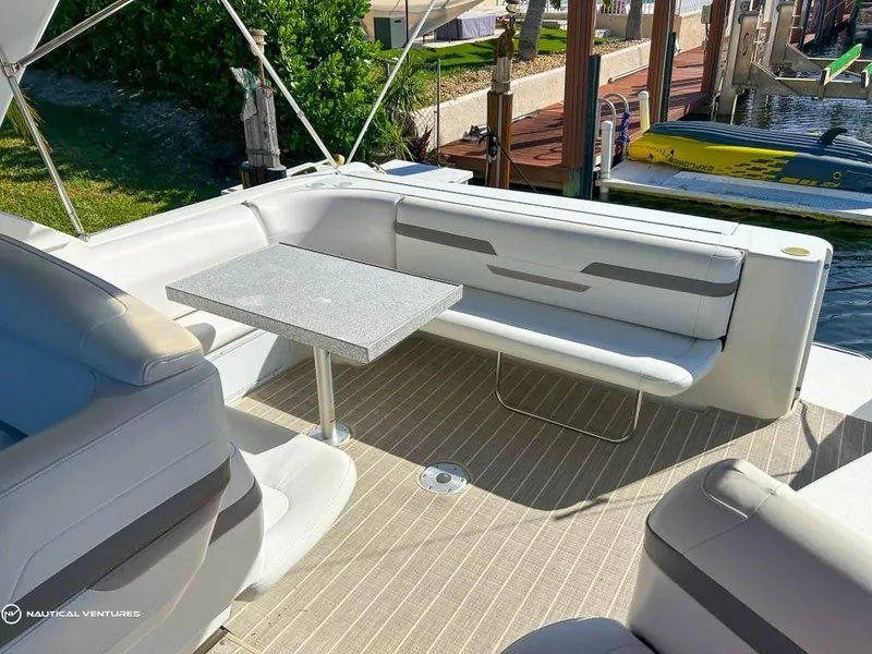 Slide: The Image of 2002 Formula 41 PC yacht with outdoor seating and table, docked by the water. - 16