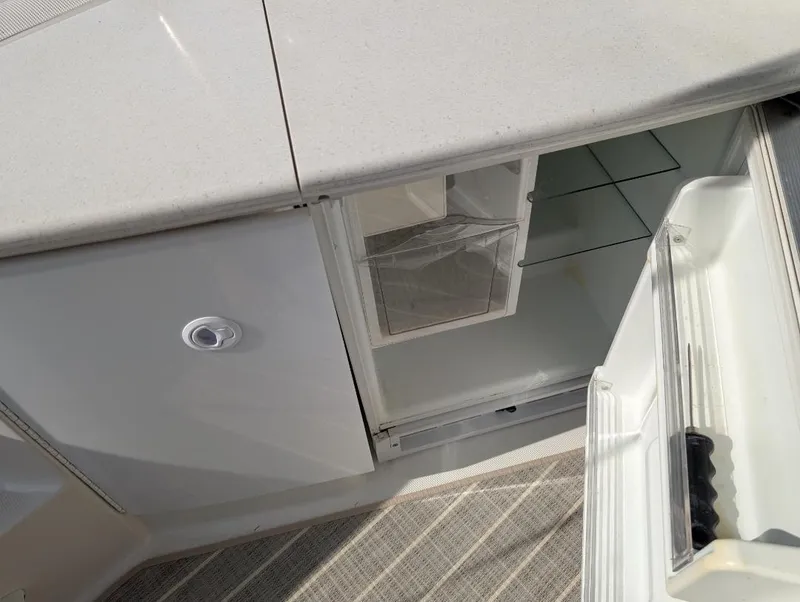 Slide: The Image of 2002 Formula 41 PC yacht interior with open fridge and storage compartments. - 17