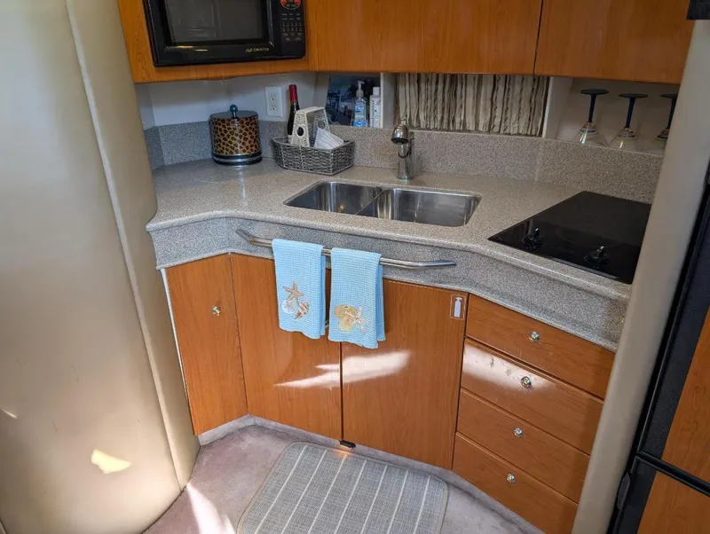 Slide: The Image of 2002 Formula 41 PC yacht kitchen with sink, stove, and wooden cabinetry. - 24