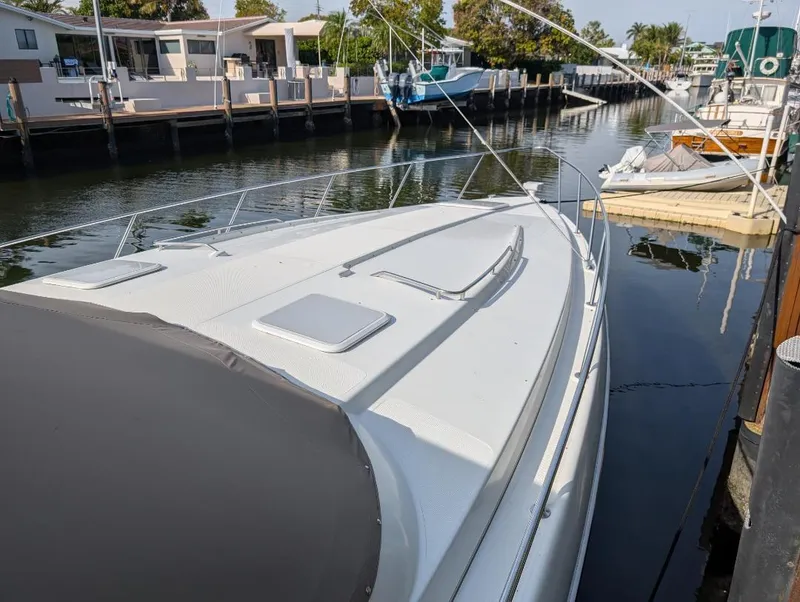 Slide: The Image of 2002 Formula 41 PC yacht docked in a serene marina setting. - 3