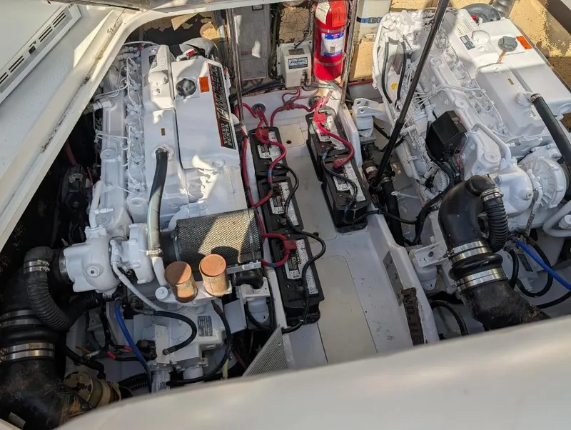 Slide: The Image of Engine compartment of a 2002 Formula 41 PC boat, featuring dual engines and fire extinguisher. - 33