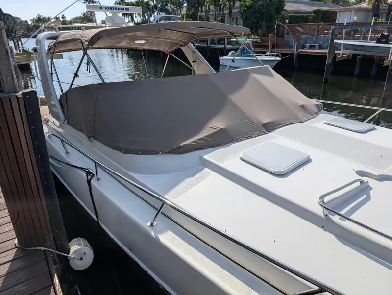 Slide: The Image of 2002 Formula 41 PC boat docked with canopy cover, in a marina setting. - 6