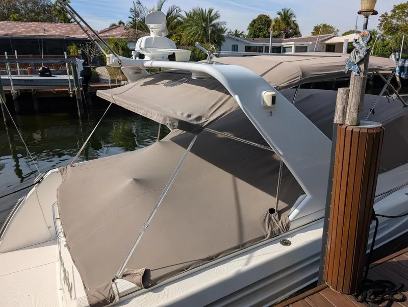 Slide: The Image of 2002 Formula 41 PC yacht docked, featuring beige canopy and sleek design. - 7