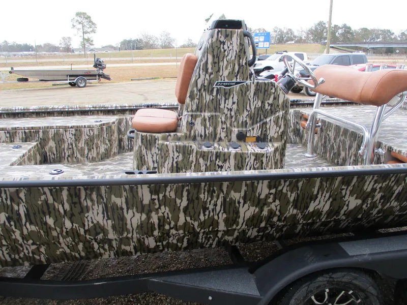 Slide: The Image of 2025 Avid 22 RECON CC boat with camouflage design and tan seating. - 3