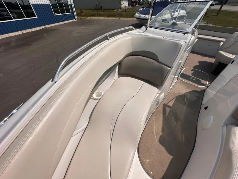 Slide: The Image of 1999 Four Winns 240 Horizon boat interior with beige seating and carpet. - 14
