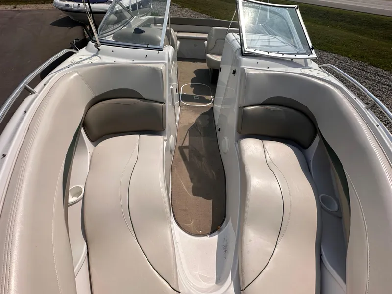Slide: The Image of 1999 Four Winns 240 Horizon boat interior with white seating and open windshield. - 16