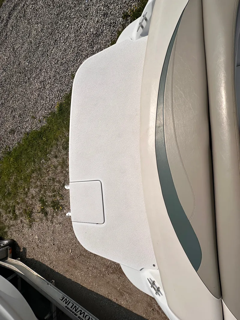 Slide: The Image of 1999 Four Winns 240 Horizon boat deck, featuring beige upholstery and a clean surface. - 5