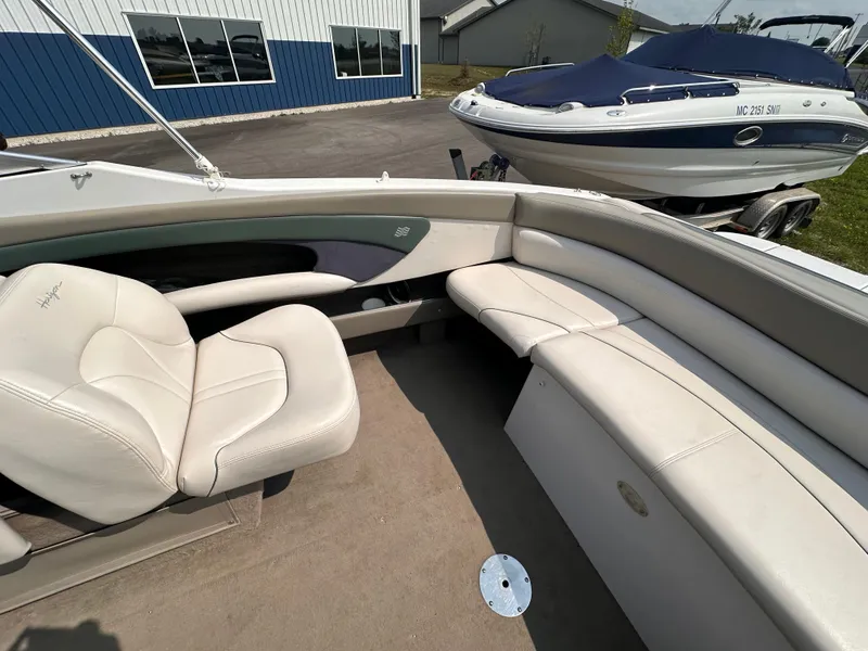 Slide: The Image of Interior of a 1999 Four Winns 240 Horizon boat with white seating. - 7