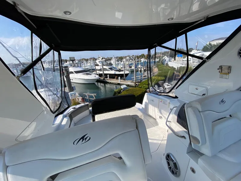 Slide: The Image of Interior view of 2015 Monterey 335 Sport Yacht overlooking marina with multiple boats docked. - 13