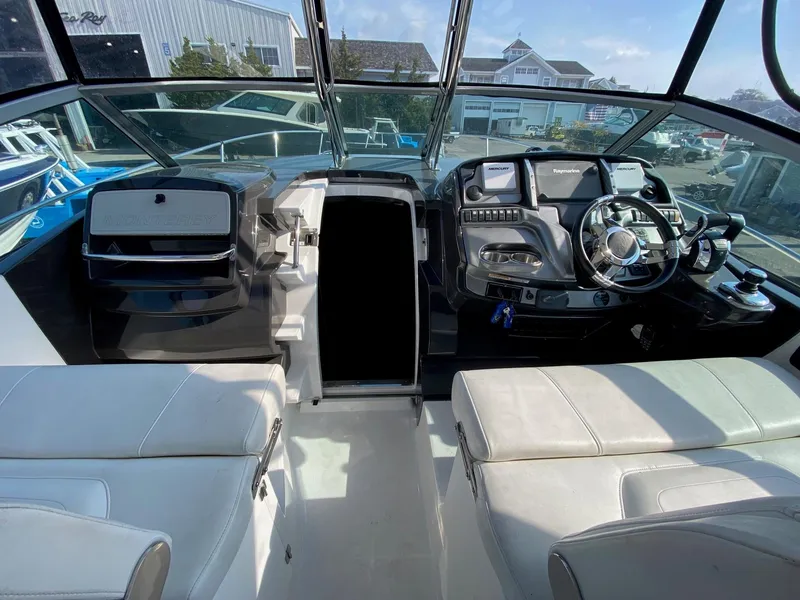Slide: The Image of 2015 Monterey 335 Sport Yacht cockpit with modern controls and seating. - 14