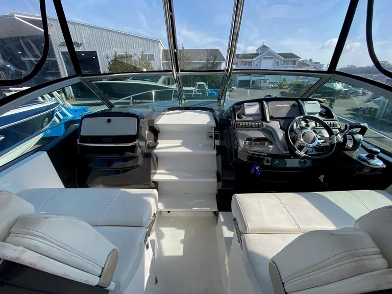 Slide: The Image of 2015 Monterey 335 Sport Yacht cockpit with steering wheel and navigation controls. - 15