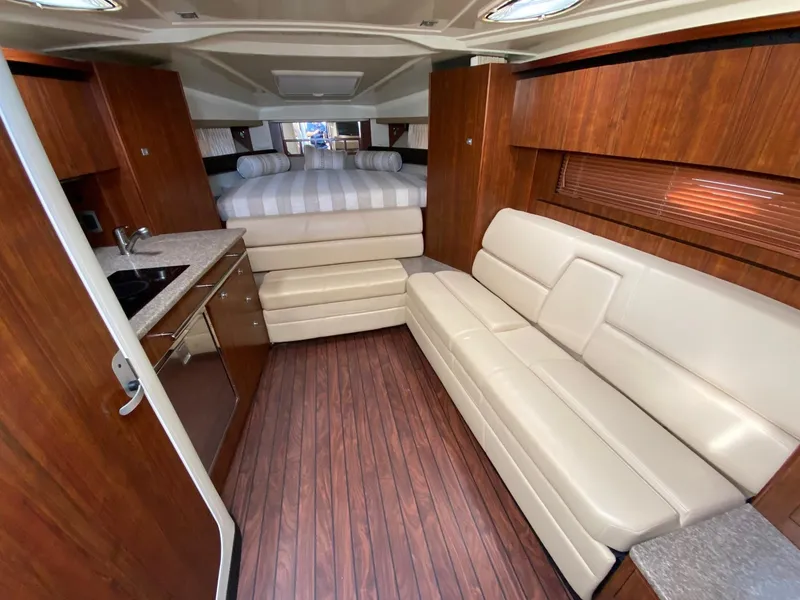 Slide: The Image of Luxurious interior of a 2015 Monterey 335 Sport Yacht with leather seating and wood finishes. - 16