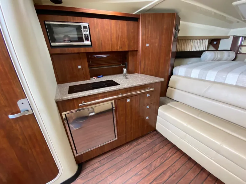 Slide: The Image of Interior of 2015 Monterey 335 Sport Yacht with kitchenette and seating area. - 17